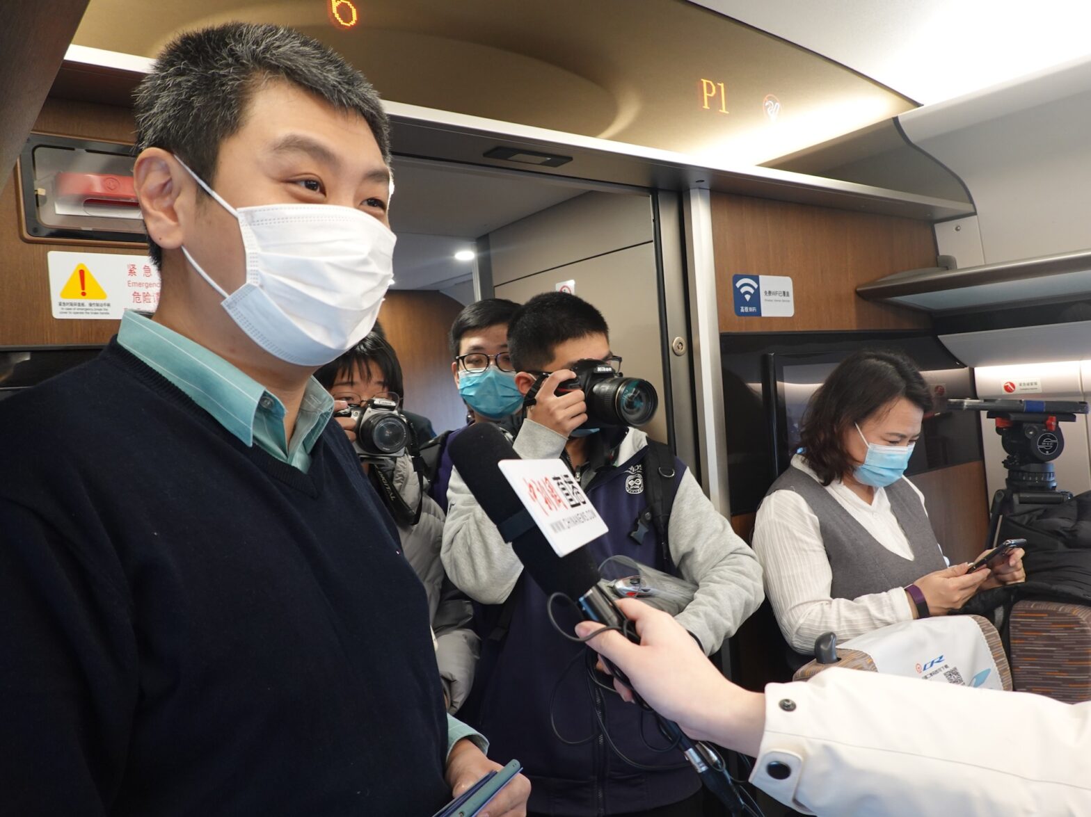 An image of David Feng being interviewed on the first Beijing-Xiongan intercity train to Xiongan