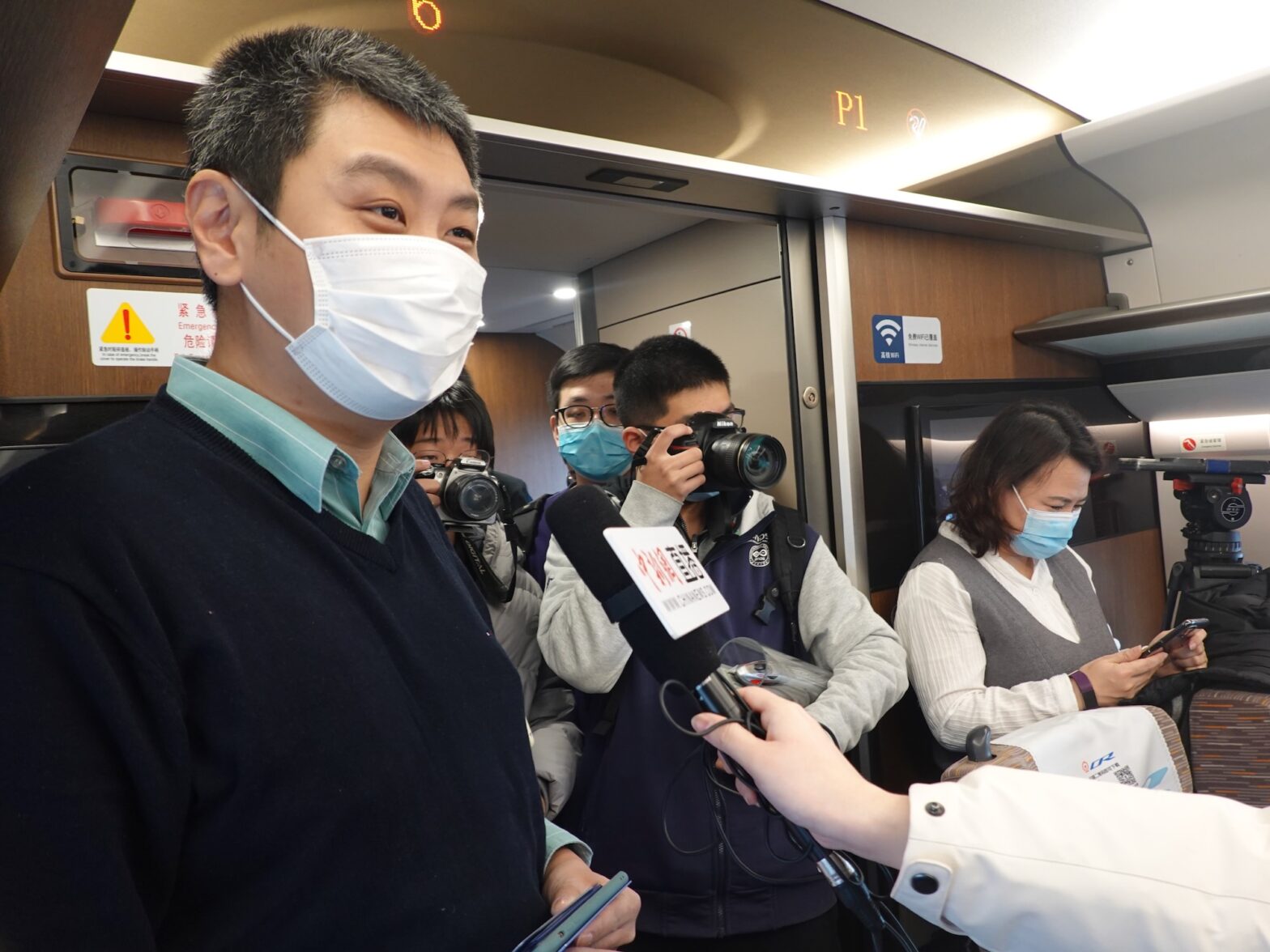 An image of David Feng being interviewed onboard a train