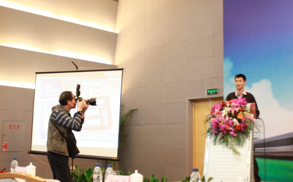 An image of David Feng giving a presentation about trains in Beijing